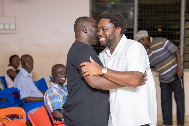Kow embracing a party member at a meeting in Ablekuma West